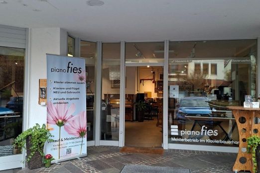 Eingang mit Rollup Banner und Schaufenster Beschriftung zum Klavierhaus Piano Fies in Oberkirch.